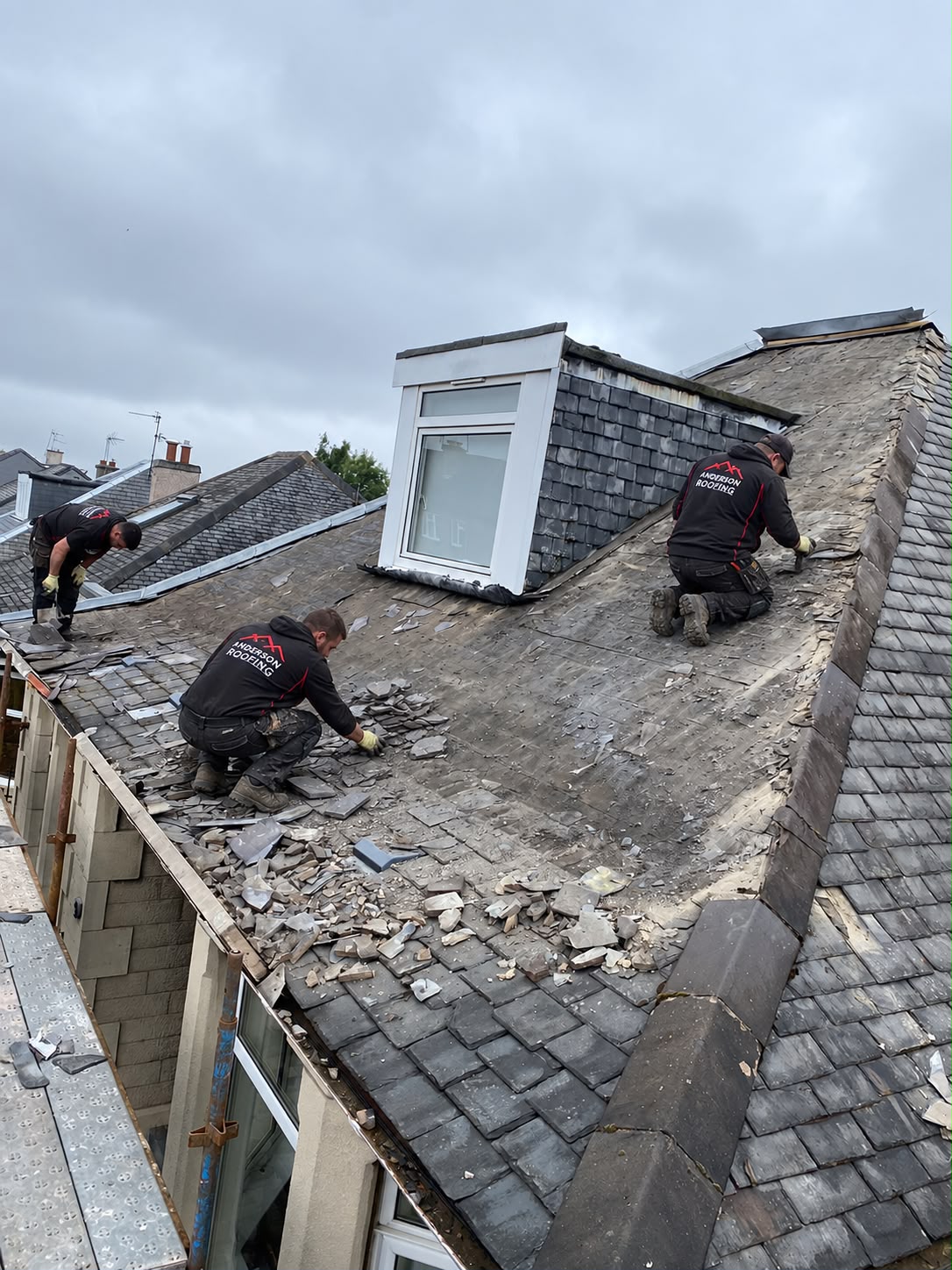 Anderson Roofing team re-slating a roof in Falkirk